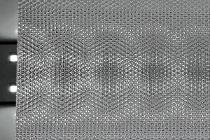Backlit honeycomb prismatic sheet showing illuminated hexagon light pattern