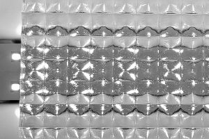 Backlit Plexicube prism sheet showing illuminated prismatic pattern