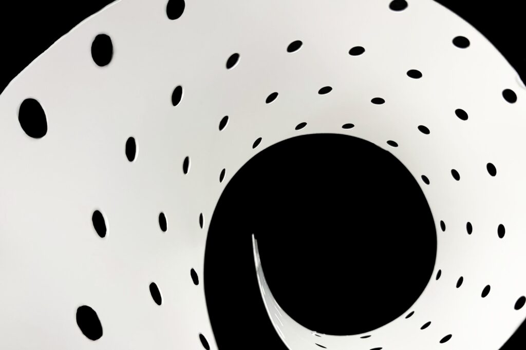 White reflector film with spiral perforation pattern