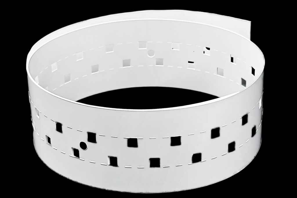 White reflector film roll with punched perforations for LED strip integration