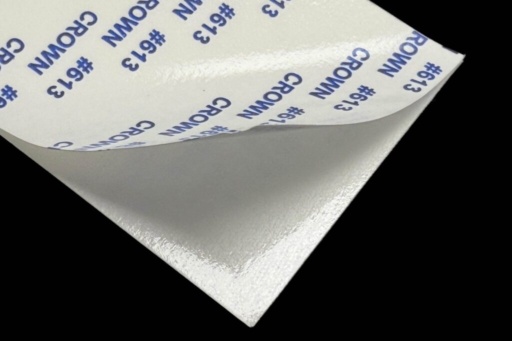 Adhesive-backed white reflector film with release liner peeled back